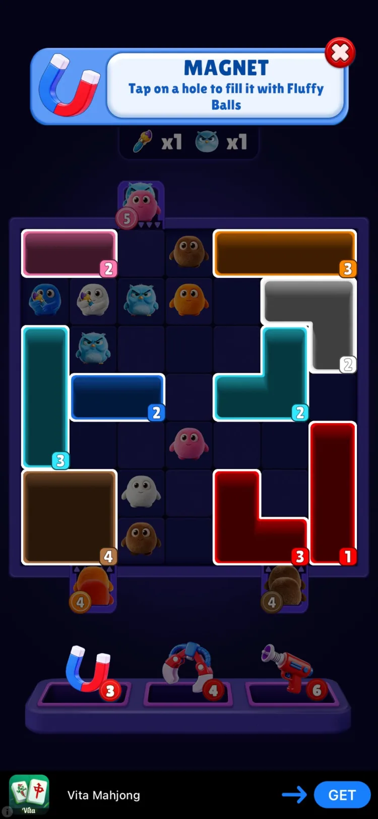 The magnet tool tooltip in Fluffy Drop, reading "Tap on a hole to fill it with Fluffy Balls", above a busier board with more colours and characters in play