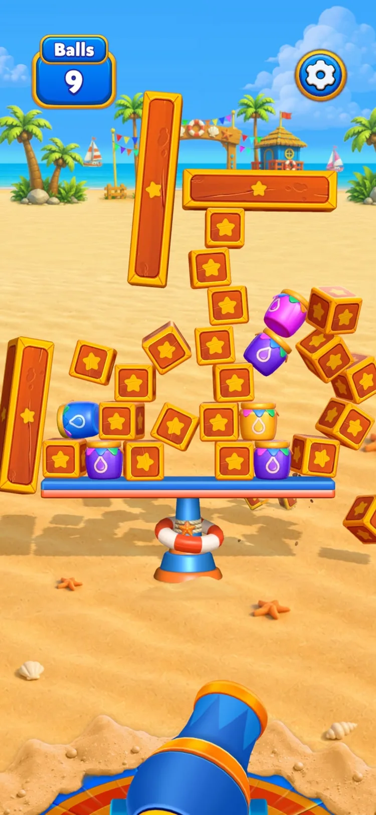 A structure of star blocks and paint jars caught mid-collapse, pieces tumbling off both sides of the platform